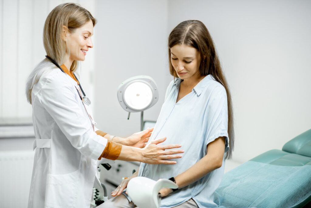 Pregnant woman consulting with her doctor