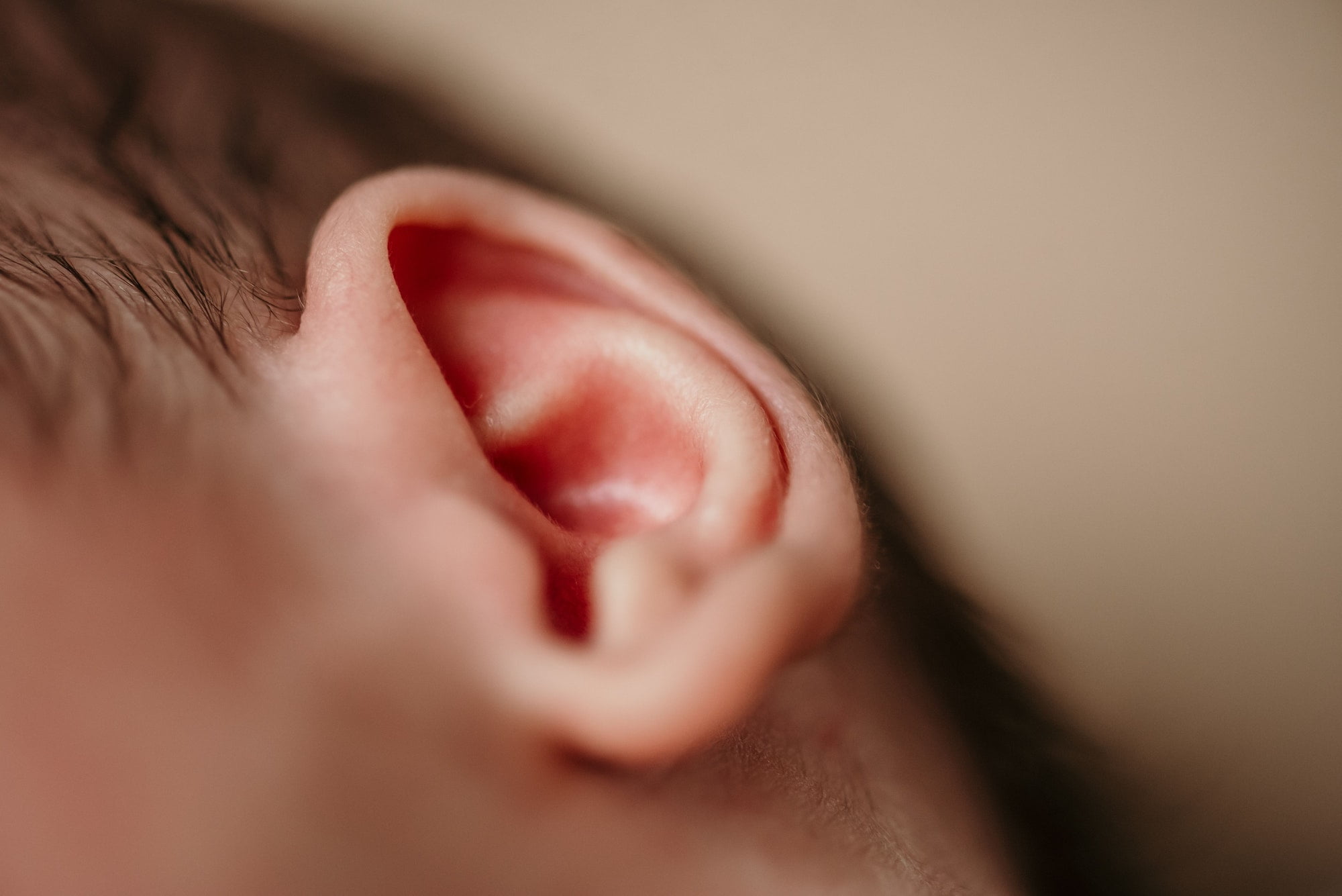 Closeup shot of the small ear of the newborn baby. Newborn Ear Color Determine Skin Color? Debunking Myths!